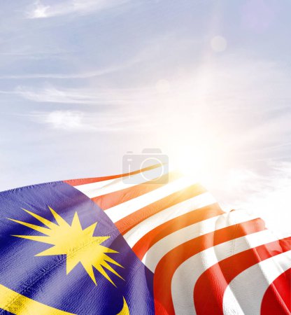 Photo for Malaysia waving flag against blue sky with clouds - Royalty Free Image