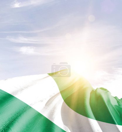 Photo for Nigeria waving flag against blue sky with clouds - Royalty Free Image