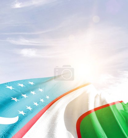 Photo for Uzbekistan waving flag in beautiful sky with sun - Royalty Free Image