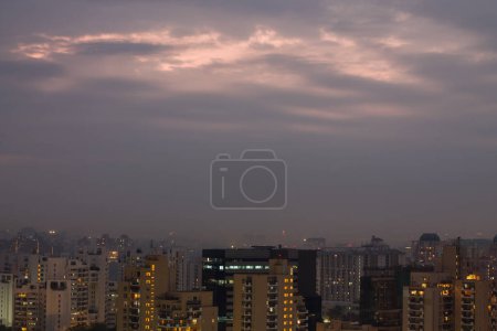 Gurgaon,Haryana,India colorful sunset on a foggy winter evening.Aerial view of Gurugram urban cityscape with modern architecture,commercial,luxury residential apartment buildings.Delhi NCR beautiful skyline with city lights.