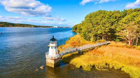 Photo for Image of Aerial over small lighthouse in Maine with warm light - Royalty Free Image