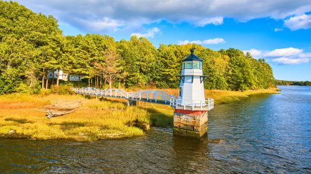 Photo for Image of Fall foliage on coast with small lighthouse in Maine and walkway - Royalty Free Image