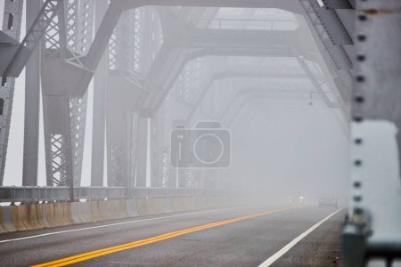 Photo for Image of Looking down old steel bridge on extreme foggy morning with cars - Royalty Free Image