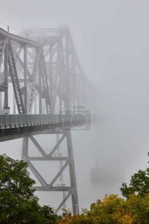 Photo for Image of View from outside of huge steel bridge fading away into nothing on extreme foggy weather morning - Royalty Free Image