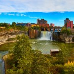 Image of Beautiful Rochester city skyline from river canyon with huge waterfall over cliffs
