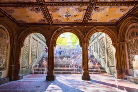 Photo for Image of Crowded Central Park staircase through limestone arches with murals on ceiling and faded people - Royalty Free Image