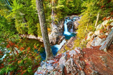 Photo for Image of On trail cliff edge overlooking beautiful blue waterfalls pouring into rocky buckets of canyon - Royalty Free Image