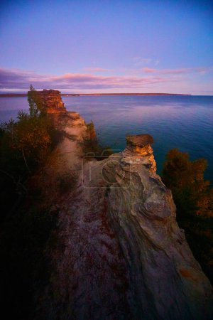 Photo for Image of Miners castle overlooking a great lake at twilight with purple and pink clouds - Royalty Free Image