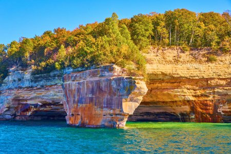 Photo for Image of Pictured rocks with iron red and green summer trees on cliffs overlooking turquoise green waters - Royalty Free Image