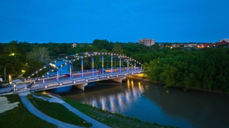 Photo for Image of MLK bridge at dusk with night lights leading into Headwaters Park aerial - Royalty Free Image