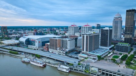 Photo for Image of River boats aerial next to downtown city Louisville Kentucky US skyscrapers - Royalty Free Image