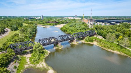 Photo for Image of Train bridge over Scioto River with forested area aerial - Royalty Free Image