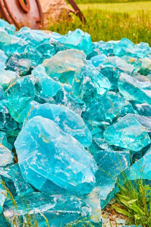 Foto de Imagen de Pila de cristales de vidrio azul turbio colocados en el campo herboso activo de fondo vertical - Imagen libre de derechos