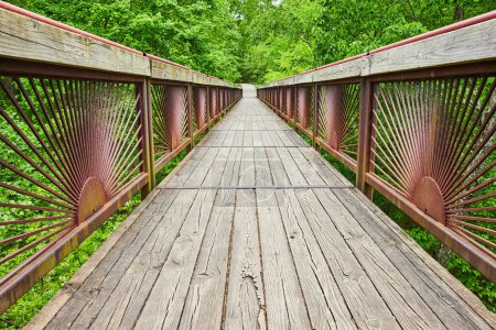 Photo for Image of Low angle on gorgeous bridge leading into lush green forest with trail at Bernheim Forest park - Royalty Free Image
