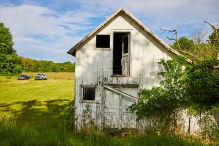 Photo for Image of Abandoned and decaying house in country with busted doors and window with overgrowth - Royalty Free Image