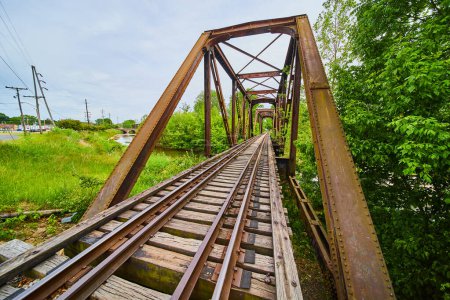 Image of Rusty truss iron railroad bridge with train tracks over Kokosing River in Mount Vernon Ohio
