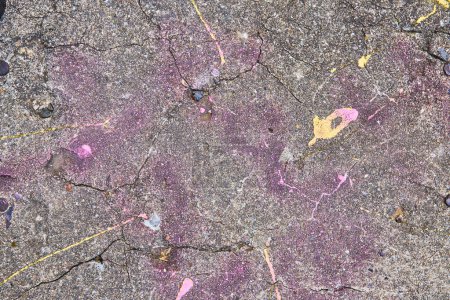 Photo for Image of Concrete wall textured with faint pink and purple spray paint and yellow paint blob - Royalty Free Image