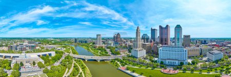 Photo for Image of Aerial panorama downtown Columbus Ohio bright blue sky with clouds and bridge over Scioto river - Royalty Free Image