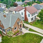 Image of Aerial old brick building in neighborhood with landscaped lawns