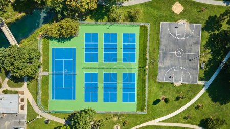 Image of Straight down aerial tennis courts and basketball court on summer day