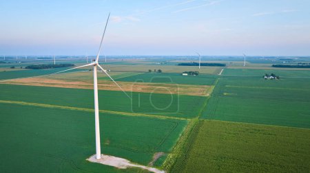 Photo for Image of Early morning aerial wind farm turbines in lush green farmland with soft pink skies - Royalty Free Image