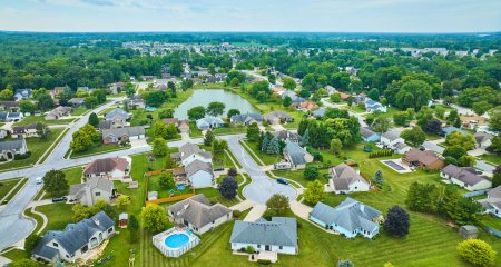 Image of Neighborhood with variety of homes and houses with fences and pool and variety of trees aerial