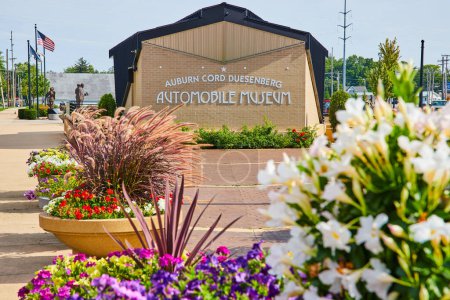 Photo for Image of Multiple flower pots with colorful assortment of flowers in front of ACD automobile museum sign - Royalty Free Image