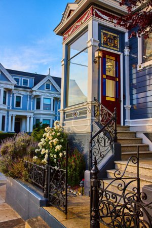 Photo for Image of Close view of front door to blue 722 The Painted Ladies house with white rose bush out front - Royalty Free Image