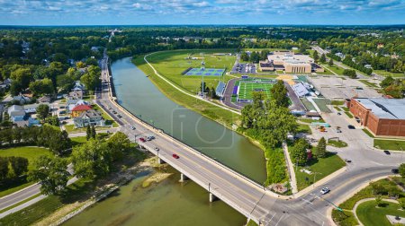 Photo for Image of White River splitting neighborhood and Muncie Central and Indiana Early College High School aerial - Royalty Free Image