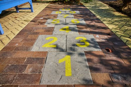 Photo for Image of Hopscotch kids game with yellow numbers on brick path at Minnetrista Museum and Gardens - Royalty Free Image