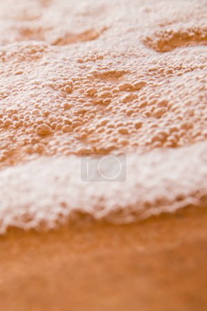 Photo for Close-up view of foamy, intricate bubbles in warm brown hue. Taken on beaches of Lake Michigan. - Royalty Free Image