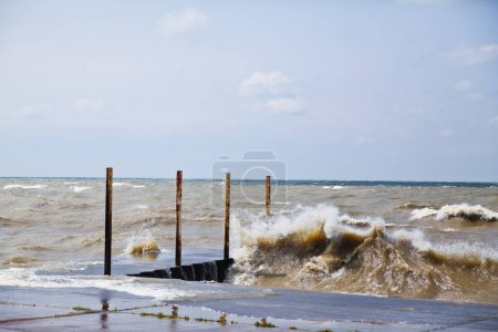 Téléchargez les photos : Masse côtière résiliente luttant contre les puissantes mers orageuses - Puissance des natures dramatiques au rivage du lac Michigans - en image libre de droit