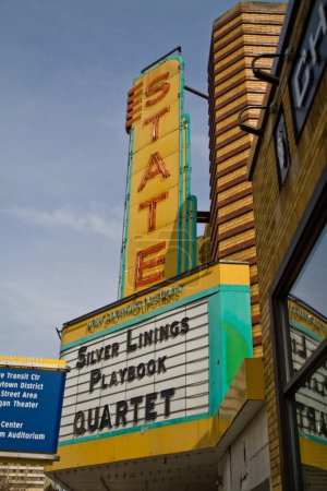 Photo for Vibrant vintage theater marquee on State Street in Ann Arbor, Michigan. Neon letters illuminate the titles Silver Linings Playbook and Quartet. Nostalgic charm meets the excitement of cinema. - Royalty Free Image