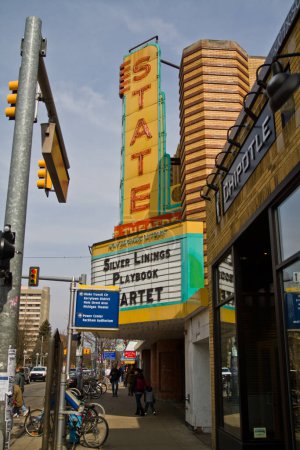 Photo for Experience the vibrant blend of history and modernity in downtown Ann Arbor, MI. The iconic STATE theater marquee shines bright, promoting Silver Linings Playbook, while Chipotle stands as a - Royalty Free Image