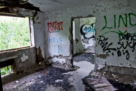 Photo for Captivating urban decay: Abandoned TB hospital in Lima, Ohio showcases a derelict interior with peeling paint, scattered debris, and vibrant graffiti tags. Explore the passage of time and the impact - Royalty Free Image