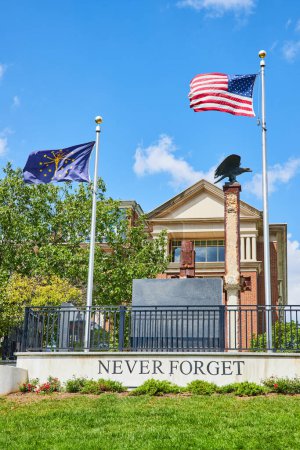 Photo for Patriotic Memorial in Indianapolis with Eagle Sculpture, Never Forget Inscription, and U.S. Flags - Royalty Free Image