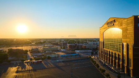 Photo for Sunrise over Lucas Oil Stadium in Indianapolis, captured by drone for an aerial view showcasing the sports venue against a beautiful urban cityscape. - Royalty Free Image