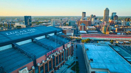 Photo for Aerial view of Lucas Oil Stadium at golden hour, with Indianapolis cityscape backdrop, 2023 - Royalty Free Image