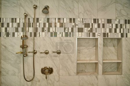 Photo for Modern Luxurious Bathroom in Michigan Home Showcases Opulent Brass Fixtures and Elegant Marble Tile Design, 2015 - Royalty Free Image