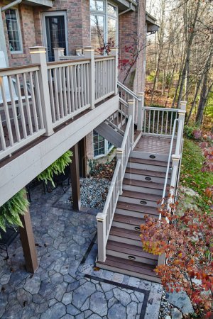 Autumn view of a multi-level wooden deck with built-in lights in a suburban home in Fort Wayne, Indiana
