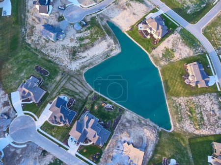 Photo for Aerial Top Down of Suburban Growth in Fort Wayne, Indiana, Showcasing Serene Residential Living and Ongoing Development by a Beautiful Blue Lake, Captured in Fall 2016 - Royalty Free Image