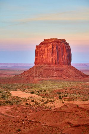 Majestic Butte in Monument Valley, Arizona bathed in golden hour light, showcasing the rugged beauty of the American Southwest from a ground view perspective, 2016