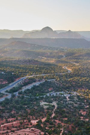 Heure d'or à Sedona, Arizona, 2016 - Vue imprenable sur la route sinueuse à travers un paysage accidenté avec des montagnes majestueuses en arrière-plan
