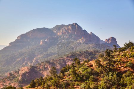 Photo for Sunlight bathes rugged red sandstone cliffs of Cathedral Rock, Arizona in 2016, showcasing untouched wilderness and natures tenacity. - Royalty Free Image