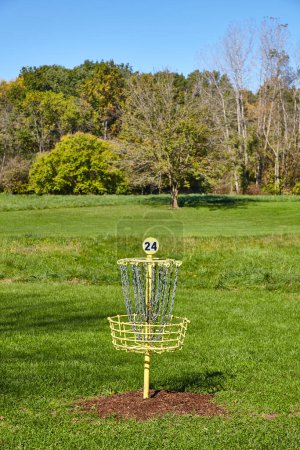 Sunny Disc Golf Course at France Park Falls, Indiana, 2016 - A serene, mid-morning view of hole 24s vibrant yellow basket on a well-manicured lawn, framed by early autumn trees.
