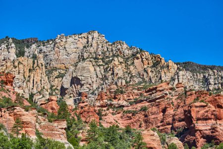 Stunning 2016 snapshot of Sedona Slide Rock State Park revealing the contrasting red rock base and layered cliffs under a clear blue sky