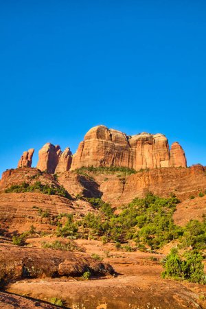 Foto de Majestic Cathedral Rock en Sedona, Arizona, se alza contra un cielo azul claro, mostrando los ricos tonos de capas sedimentarias rojas y escasa vegetación del desierto en 2016. - Imagen libre de derechos