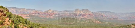 Foto de Vista panorámica del paisaje desértico de Arizonas con icónicas formaciones rocosas rojas y escasa vegetación bajo un cielo azul claro en 2016, que muestra la tranquilidad y la belleza atemporal de Sedona. - Imagen libre de derechos