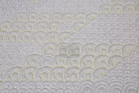 Close-up of an intricately embroidered fabric with lime green scalloped patterns on a grey background, ideal for fashion and interior design concepts, Fort Wayne, Indiana, 2017