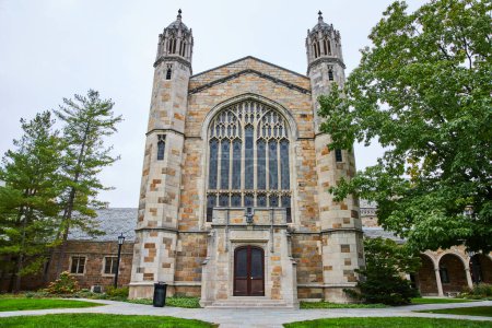 Majestic Gothic-style University of Michigan Law Quadrangle building amidst tranquil campus setting